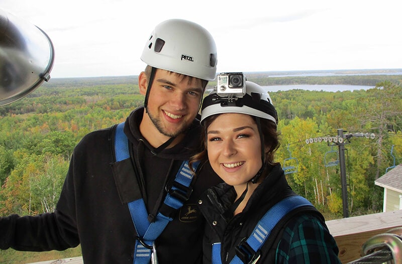 Couple poses for image during brainerd zipline tour