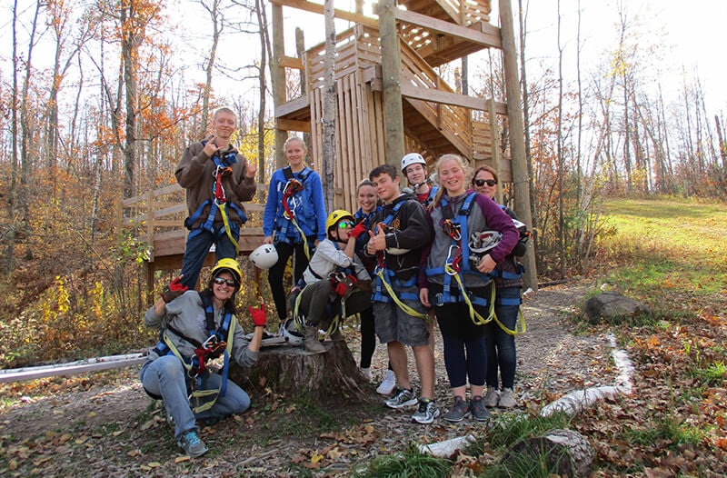 Group poses for image during brainerd zipline tour